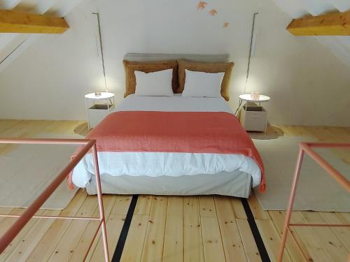 a bedroom with a large bed with two tables at Porta 4 Azeitão, holiday house in Azeitao