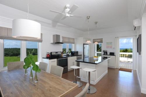 a kitchen and dining room with a table and a dining room at Buttonwood Reserve Compound - Compound withBeach, Pool, Pickleball condo in James Cistern