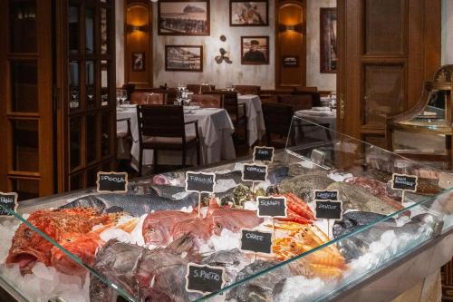 a display case filled with different types of seafood at Baglioni Hotel Luna - The Leading Hotels of the World in Venice