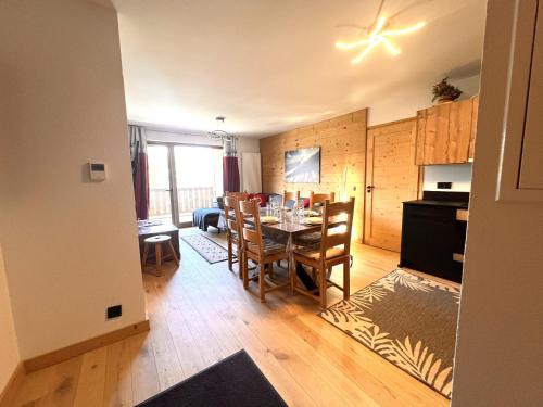 a dining room and kitchen with a table and chairs at Esprit chalet-Le Snoroc C36 in Aime La Plagne