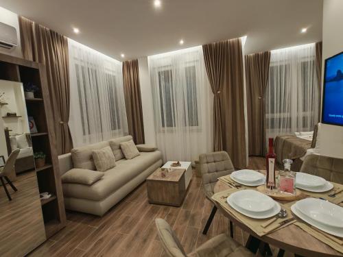 a living room with a couch and a table at POOL RESORT Vila Lena - Lux residence apartman 1 in Vrdnik