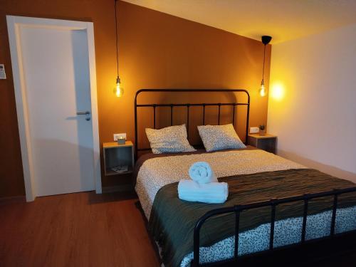 a bedroom with a bed with a towel on it at La de Simón in A Guarda