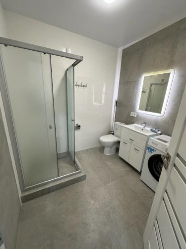 a bathroom with a shower and a toilet and a sink at ЖК Парус, 9-1 in Chornomorsk