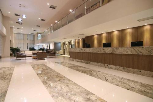 a lobby of a hotel with a reception desk at Samba Hotel Linhares in Linhares