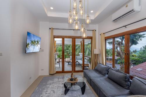 a living room with a couch and a table at BOHO Boutique Bungalows in Baan Tai