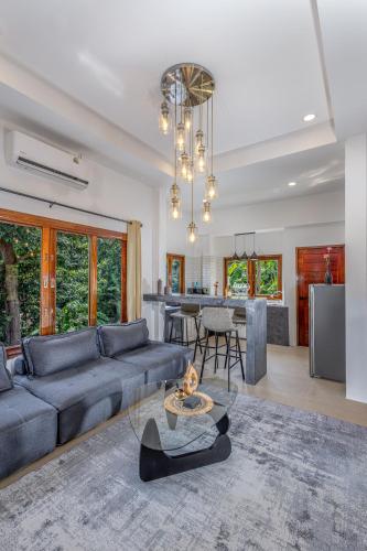 a living room with a couch and a table at BOHO Boutique Bungalows in Baan Tai