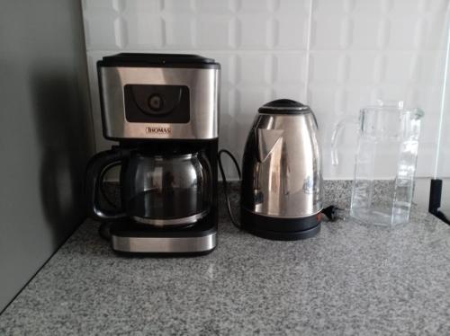 a coffee maker and a coffeemaker sitting on a counter at Alto Alborada Cercado in Lima