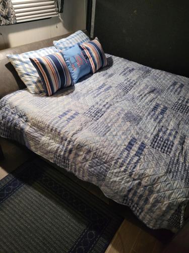 a bed with two pillows on top of it at Cozy Camping in Hot Springs