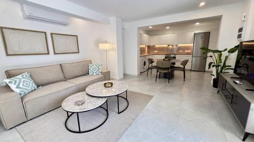 a living room with a couch and a table at Kantara Garden Apt by TrulyCyprus in Limassol