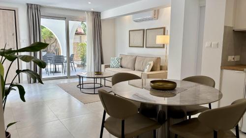 a living room with a table and chairs at Kantara Garden Apt by TrulyCyprus in Limassol