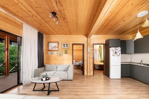 a living room with a couch and a table at Likani Verde in Borjomi