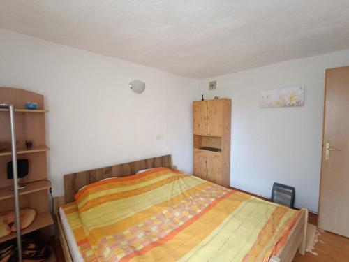 a bedroom with a bed with a wooden head board at Vlasic Relax in Vlasic