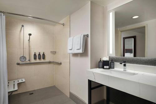 a bathroom with a sink and a mirror at Sheraton Ontario Airport Hotel in Ontario