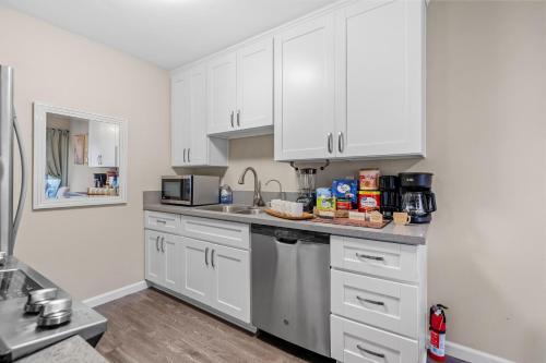 a kitchen with white cabinets and a counter top at Entire Private 2BR-1Bth King Bed, Pool, HotTub, 2 Parkings, Mira Mesa, Available Now in San Diego
