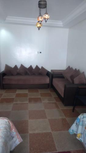 a living room with a couch in the corner of a room at khadija oulidia in Oualidia