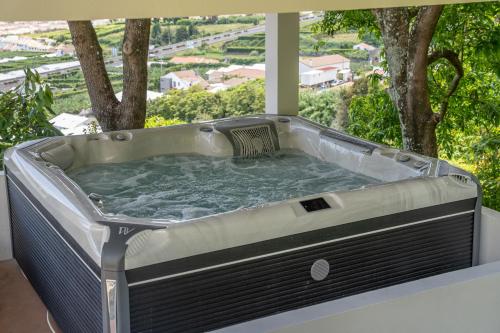 a jacuzzi tub sitting on top of a house at Vila Islet View in Vila Franca do Campo
