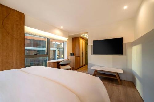 a bedroom with a bed and a flat screen tv at The Westin Sao Paulo in Sao Paulo