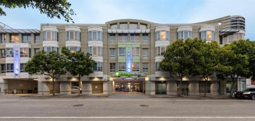 a large building with trees in front of it at Holiday Inn Express Hotel & Suites Fisherman's Wharf by IHG in San Francisco