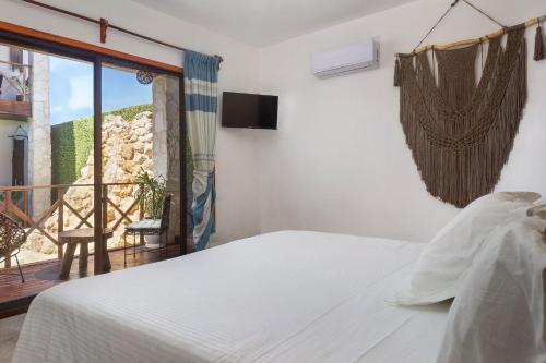 a bedroom with a bed and a balcony at Lagoon Boutique Hotel - Luxury Chaman experience in Tulum