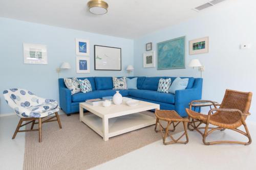 a living room with a blue couch and chairs at Holiday House Palm Springs in Palm Springs