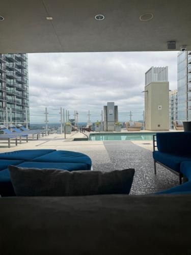 a room with blue couches and a swimming pool at Luxury Midtown High-rise Oasis! in Atlanta