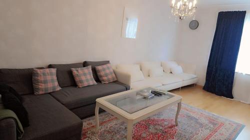 a living room with a couch and a coffee table at The castle & stay in Örebro