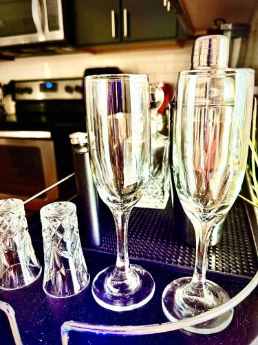 three empty wine glasses sitting on top of a counter at Luxury Midtown High-rise Oasis! in Atlanta