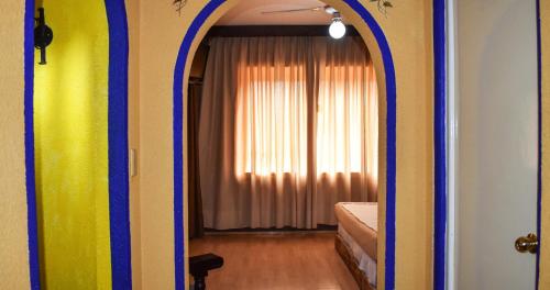 a room with a door leading to a bedroom at Hotel Benedicta in Mexico City