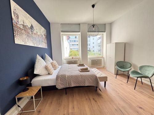 a bedroom with a bed and a table and chairs at XXL City Apartment - 5 bedrooms - free parking - MalliBase Apartments in Hannover