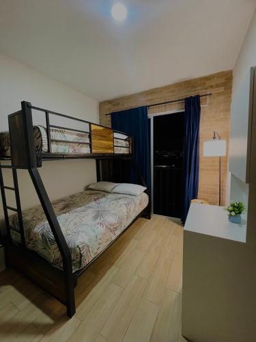 a bedroom with a bunk bed in a room at RINCÓN DE MONTE ALBAN Oaxaca in Oaxaca City