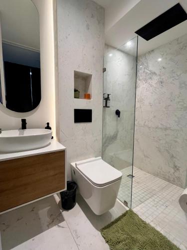 a bathroom with a toilet and a sink and a shower at I811 LOFT AC premium amenities in Mexico City