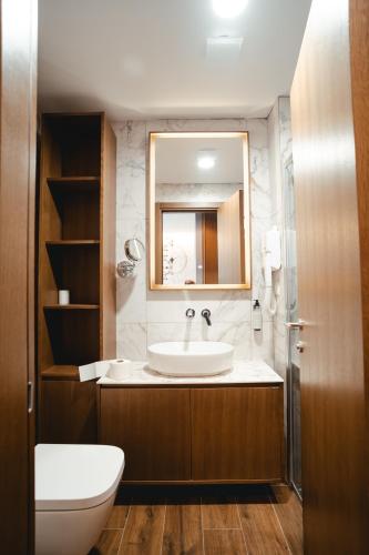 a bathroom with a sink and a mirror at Zlatibor Lux Spa Apartments in Zlatibor