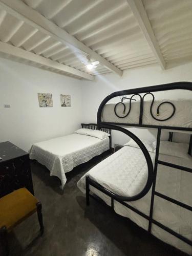 a room with two bunk beds and a table at Wanchaka House in Huanchaco