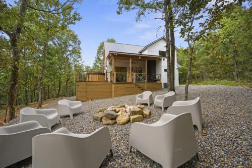 a group of white chairs in front of a house at A-Frame of Mind - Modern Farmhouse in Stephens Gap