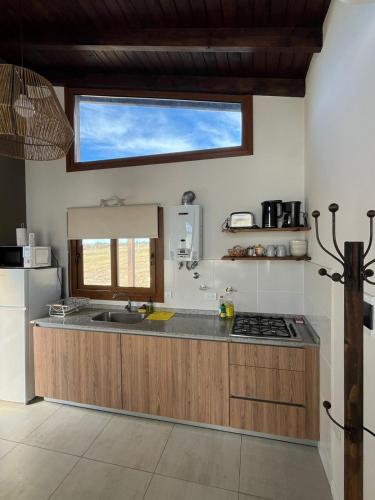a kitchen with a sink and a counter top at Las Champas in Villa Yacanto