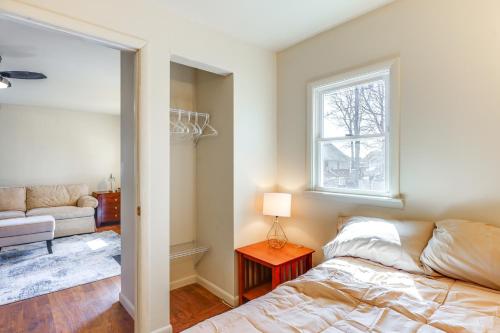 a bedroom with a bed and a window and a couch at 1 Mi to Dtwn Saratoga Springs Cozy Duplex Apt! in Saratoga Springs