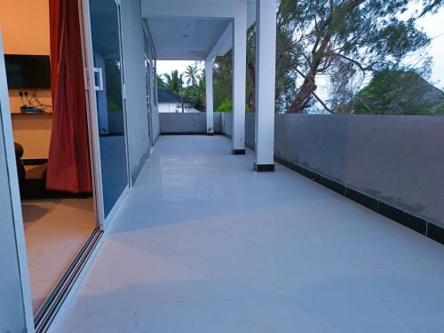 an empty hallway of a house with aoicellular at 2BR Beachfront Apartment with Balcony & Sea Views - Uroa, Zanzibar in Uroa