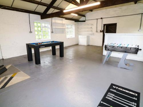 a room with a ping pong table in the middle at Oxcroft View in Worksop