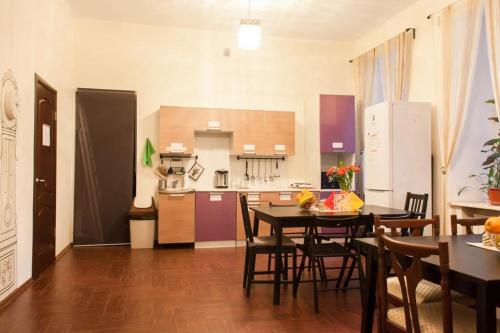 a kitchen and dining room with a table and chairs at Hostel Udacha in Saint Petersburg