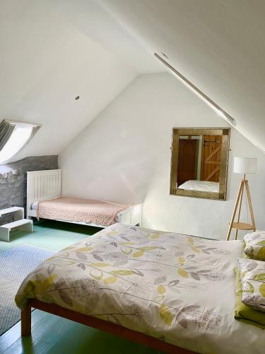 a bedroom with a bed and a mirror on the wall at The Cottage @ Mill Haven place in Pembrokeshire
