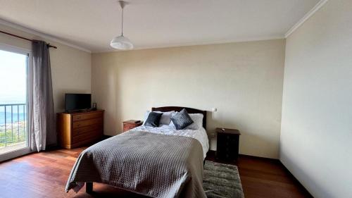 a bedroom with a bed and a large window at Golden View in Gaula