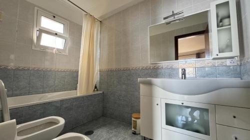 a bathroom with a sink and a toilet and a mirror at Golden View in Gaula