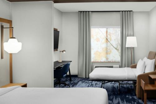 a hotel room with two beds and a desk at Fairfield Inn & Suites Riverside Corona/Norco in Norco