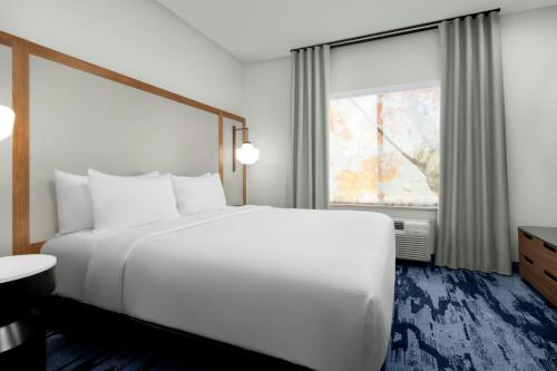 a bedroom with a large white bed and a window at Fairfield Inn & Suites Riverside Corona/Norco in Norco