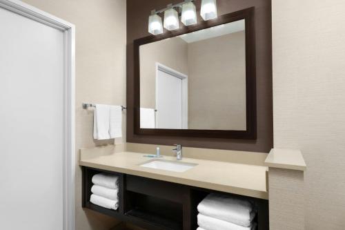 a bathroom with a sink and a mirror at Fairfield Inn & Suites Riverside Corona/Norco in Norco
