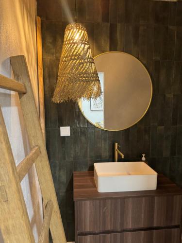 a bathroom with a sink and a mirror at Casa Oliveira in Silves