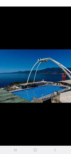a bridge over a body of water next to the ocean at Blue Apartment G&G in Rijeka