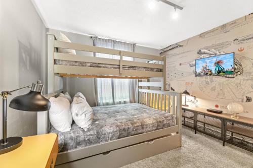 a bedroom with a bunk bed and a desk at Near Disney 4BR with Private Pool in Kissimmee