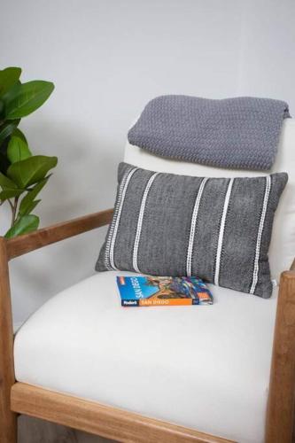 a stack of pillows sitting on a chair at Stylish, Elegant, Modern, King Bed in San Diego