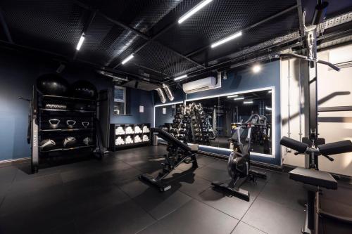 a gym with treadmills and machines in a room at Hotel Indigo Leeds by IHG in Leeds